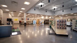 Spacious lobby at Green Top Shooting Range with rentals desk, retail displays, and flags on the wall.